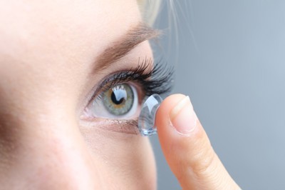 Woman putting in contact lens